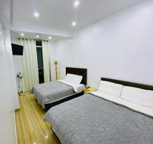 a hotel room with two beds and a television at Hurin Perú in Ica +24 photos