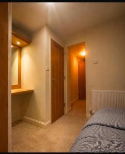 a bedroom with a bed and a wooden door at The barn in Carmarthen