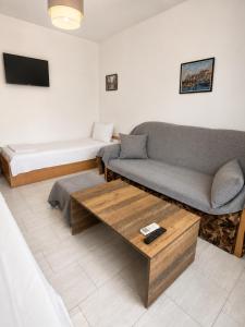 a living room with a couch and a bed at AnaBella Apartments Gabrovo in Gabrovo