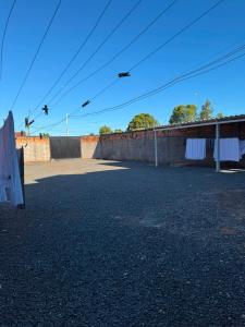 an empty parking lot next to a brick wall at Rosmarry Hotel in Colinas do Tocantins
