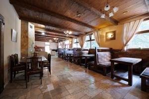 a dining room with wooden tables and chairs at Moto pub Marusja in Snina