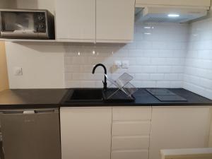 a kitchen counter with a sink and a microwave at Renovated studio in Le Crès in Le Crès