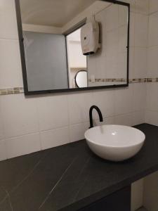 a bathroom with a white sink and a mirror at Renovated studio in Le Crès in Le Crès
