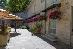 a courtyard with plants and flowers in a building at Nunne Boutique Hotel in Tallinn