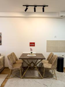 a dining room with a wooden table and chairs at Apartman Mario in Čačak
