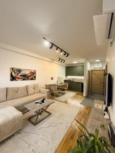 a living room with a couch and a table at Apartman Mario in Čačak