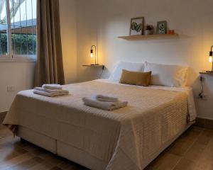 a bedroom with a large bed with towels on it at Casa de los Cerros II in Vaqueros