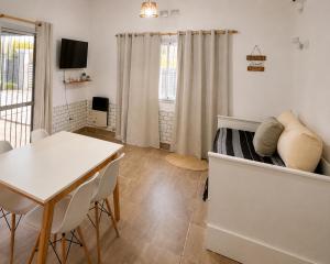 a bedroom with a bed and a table and chairs at Casa de los Cerros II in Vaqueros