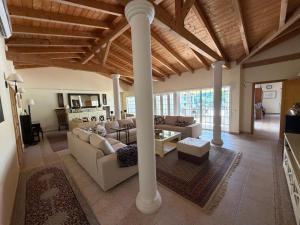 a living room with a couch and a table at Luxury Villa near Vila Sol Golf Resort - Pool & Garden in Quarteira