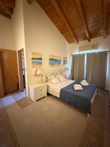 a bedroom with a bed and a table with a lamp at Luxury Villa near Vila Sol Golf Resort - Pool & Garden in Quarteira +25 photos