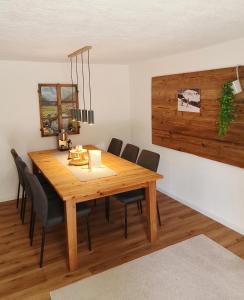 a dining room with a wooden table and chairs at Haus am Seebach Leutasch Weidach in Leutasch
