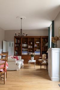 a living room with a white couch and chairs at Gîte de LA CHESNAYE in Cerelles