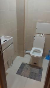 a small bathroom with a toilet and a sink at Ayden Residence Béjaïa in Bejaïa