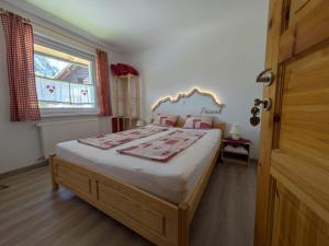 a bedroom with a large bed and a window at Gorski biser in Mojstrana