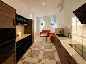 a kitchen with a sink and a living room at Welcome Hostel in Churriana