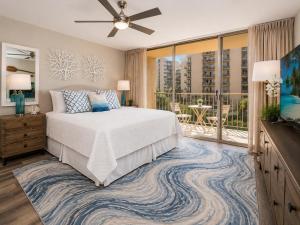 a bedroom with a large bed and a balcony at Royal Kahana 318 Studio Condo in Kahana