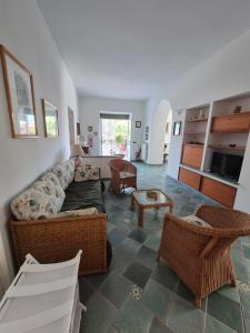 a living room with a couch and chairs at Casa Cachepot - Sweet Silvana in Ischia