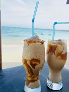 two drinks are sitting on a table near the beach at Vista Linda Cabaña in Playa Blanca +95 photos