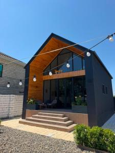 a house with a staircase in front of it at Calm Barnhouse Lankaran in Lankaran