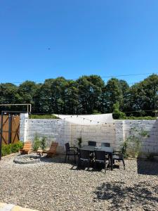 a patio with a table and chairs and a brick wall at Calm Barnhouse Lankaran in Lankaran +14 photos