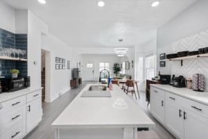 a kitchen with white cabinets and a white counter top at Ogden Base Camp in Ogden