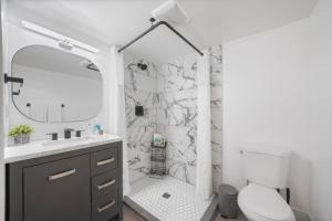 a bathroom with a shower with a sink and a toilet at Ogden Base Camp in Ogden +34 photos