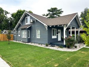 a blue house with a yard at Ogden Base Camp in Ogden