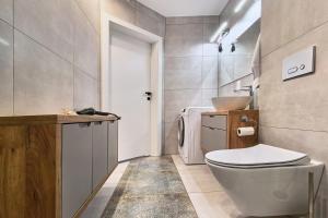 a bathroom with a toilet and a sink at Apartament Kaskady75 in Łańcut +20 photos