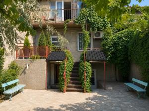 a building with a staircase and two benches in front of it at Sunshine Boutique Hostel in Yerevan