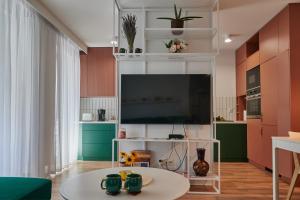 a living room with a tv and a table at Apartament Kaskady75 in Łańcut