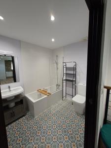 a bathroom with a tub and a toilet and a sink at La Casona de Regolfo in Regolfo +47 photos