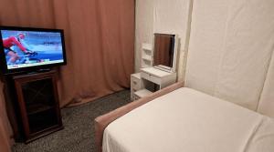 a hotel room with a television and a bed at Cozy Private Room Near Everything in Kent