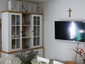 a living room with a tv and a white cabinet at Kuća za odmor Mate 
