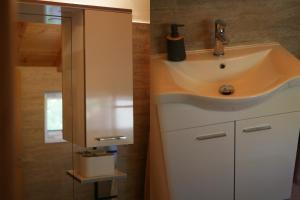 a bathroom with a sink and a mirror at Kuća za odmor Mate  +29 photos