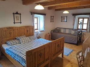 a bedroom with a bed and two bunk beds at Sudetský grunt Autentická jesenická chalupa in Loučná nad Desnou
