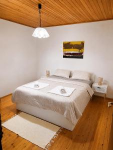 a bedroom with a bed with two towels on it at Hiža Bili in Svetvinčenat +13 photos