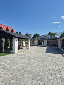 a large driveway in front of a house at Gusturi din Livadă in Costeşti-Vîlsan