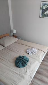 a bed with two towels on top of it at Apartman Pávai-Silye in Hajdúszoboszló +80 photos