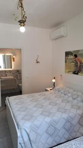 a bedroom with a large white bed in a room at B&B MAST Apartment Suite in San Pellegrino Terme