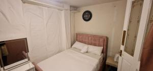 a small room with a bed and a television at Cozy Private Room Near Everything in Kent