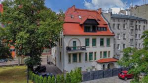 a house with an orange roof on a city street at Hotel Villa Art Novis Wrocław Centrum in Wrocław