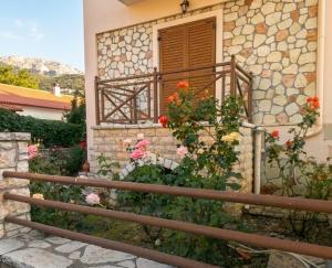 a building with a balcony with flowers on it at Dreamcatcher Maisonette No.2 in Kalavrita