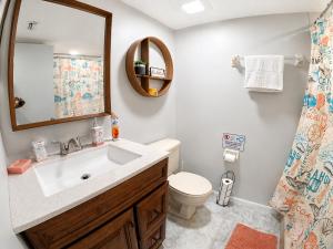 a bathroom with a sink and a toilet and a mirror at 3697 Orlando Vacational Apartment in Orlando