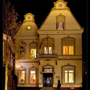 a large building with a clock on top of it at Pension Delfzijl in Delfzijl