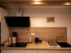 a kitchen with a counter top with a sink at Sweet Home & Spa in Erstein