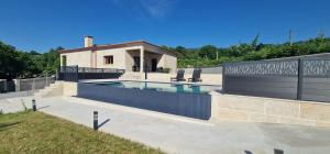 ein Swimmingpool mit zwei Stühlen neben einem Haus in der Unterkunft vila pico de regalados in Vila Verde