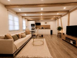 a living room with a couch and a table at Sweet Home & Spa in Erstein