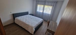 ein kleines Schlafzimmer mit einem Bett und einem Fenster in der Unterkunft vila pico de regalados in Vila Verde + 9 Fotos