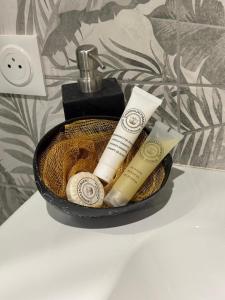 a bathroom sink with towels and a soap dispenser at Flamingo Bay in Les Trois-Îlets