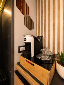 a kitchen with a coffee maker on a counter at ZONA NAVIGLI Design Loft , Proiettore schermo 80" in Milan +8 photos